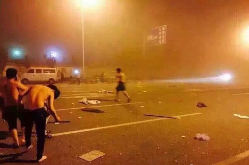 12일 중국 북부 항구도시인 톈진(天津)의 한 창고에서 폭발이 일어난 직후 부상을 입은 사람들이 거리로 뛰쳐나와 있다.